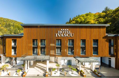 an orange building with a hotel kxsw on it at Hotel Ivascu in Moisei