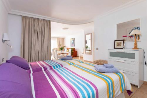 Un dormitorio con una cama grande con una manta colorida. en Vistas al Teide II Piscina climatizada 39, en Puerto de la Cruz