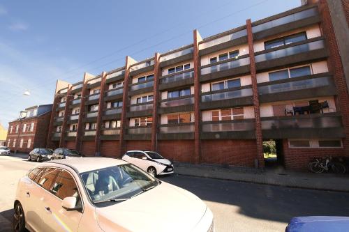 a white car parked in front of a building at (048) Vesterhavsgade 47 door 2 in Esbjerg