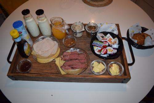 a table topped with a tray of food and drinks at Bed & breakfast Achter ons huis in Berlicum