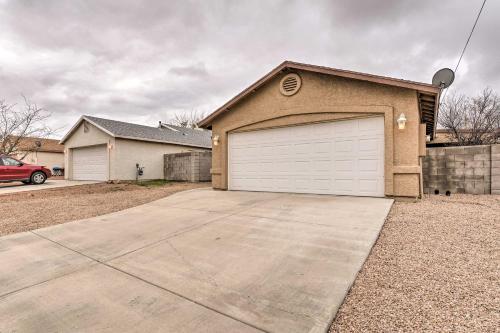 a brown house with a white garage at Kid-Friendly Kingman Home Near Parks and Dining in Kingman