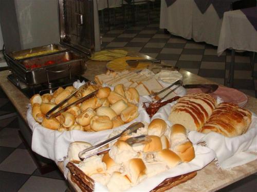 a table with various types of bread and pastries at Hotel Itamaraty in Curitiba