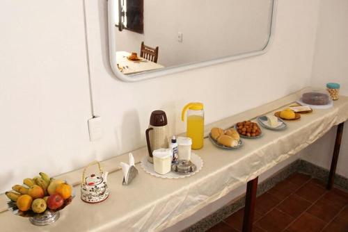 a table with fruits and other items on it at Hostel Universo in Ibicoara