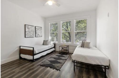 a white room with two beds and a window at Impressive Cozy Historic 2BR Apt Near Downtown in San Antonio