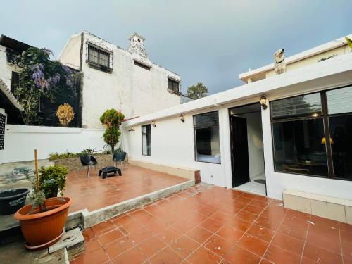 a house with a patio and a building at Casa ELA in Antigua Guatemala