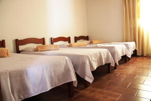 a group of four beds in a room at Hostel Universo in Ibicoara