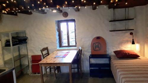 a room with a table and a bed and a window at Villa Appetite in Marmarion