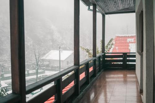 a balcony with a view of a snow covered mountain at Hanul Vanatorului in Gureni
