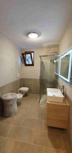 a bathroom with a shower and a toilet and a sink at Residenza Costasmeraldina in Porto Rotondo