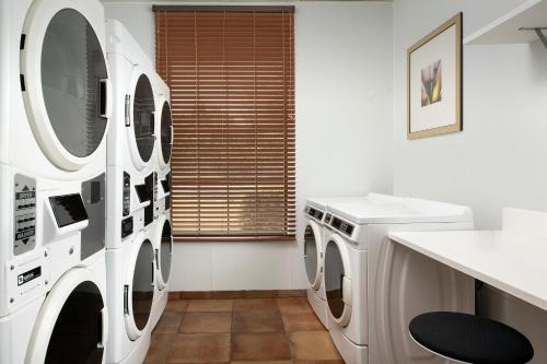 a laundry room with washing machines and a sink at Staybridge Suites North Charleston by IHG in Charleston