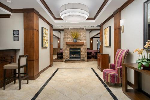 a hallway with a lobby with a fireplace at Staybridge Suites North Charleston by IHG in Charleston