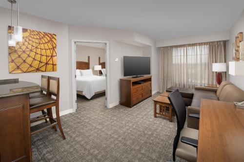 a hotel suite with a living room and a bedroom at Staybridge Suites North Charleston by IHG in Charleston
