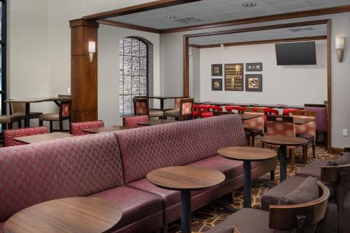 a bar with a couch and tables and chairs at Staybridge Suites North Charleston by IHG in Charleston