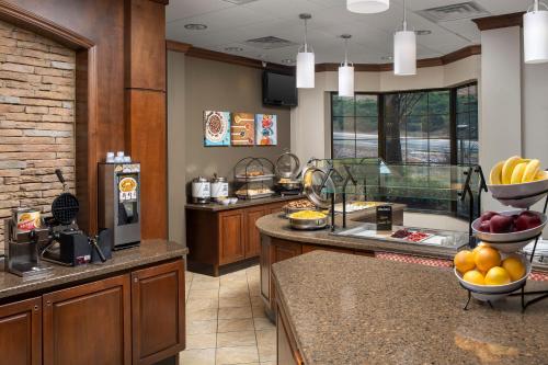 a kitchen with a counter with fruit on it at Staybridge Suites North Charleston by IHG in Charleston