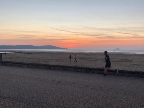 a group of people flying a kite on the beach at The Kyrenia in Weston-super-Mare