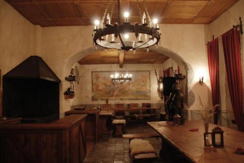 a chandelier in a room with a table and a desk at Zámek Kamenný Dvůr in Kynšperk nad Ohří