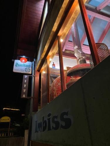 a sign for an indias restaurant in front of a window at Apartment Mölltaler Gletscher 8 in Ausserfragant