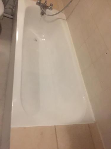 a white bath tub with a faucet in a bathroom at DACH Apartments - Cozy 3 bed Apartment in Hendon in Colindale