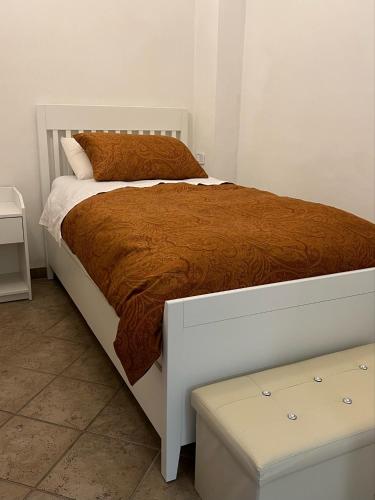 a bedroom with a large bed with a brown blanket at Casa Michelina in Vasto