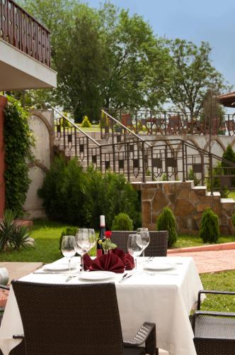 a table with a white table cloth and wine glasses at Park Hotel Arbanassi in Arbanasi