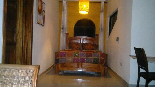 a bedroom with a bed with two cats on it at Accra Royal Castle Apartments & Suites in Kwabenya
