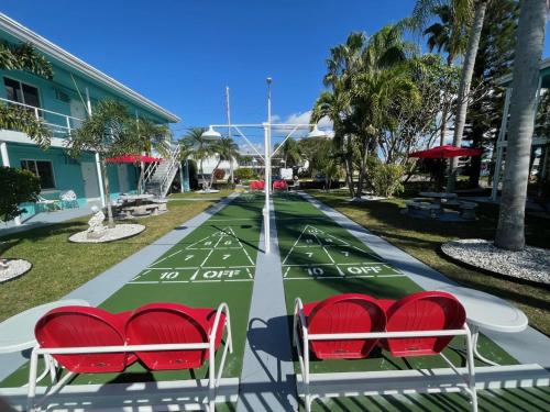 a golf course with red chairs on top of it at Sea Jay Motel and Marina in St Pete Beach