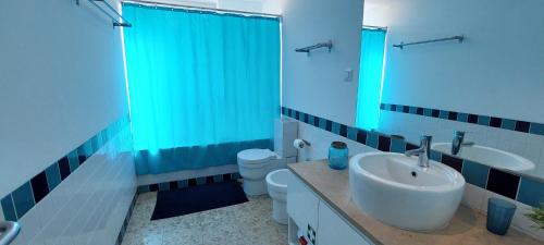 a bathroom with a sink and a toilet and a shower at Varandas de Carteia in Quarteira