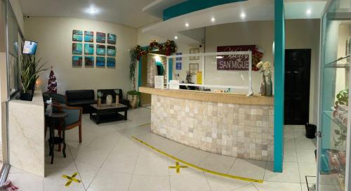 a lobby with a bar in a restaurant at Hotel San Miguel in Progreso