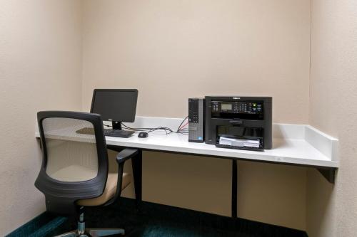 an office with a desk with a computer and a chair at Candlewood Suites Reading by IHG in Reading