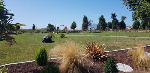 a park with a gorilla sitting in the grass at GITE EN CAMPAGNE 15 min de Rennes in Saint-Gilles