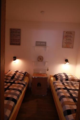 two beds in a room with lights on the wall at Th 625 Panoramic Hohegeiß in Braunlage
