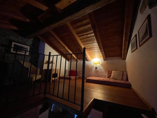 a room with a bed and a staircase in a house at Maison de Noé in Arnad
