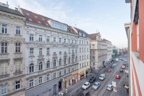 a view of a city street with cars and buildings at Dream of Belvedere in Vienna