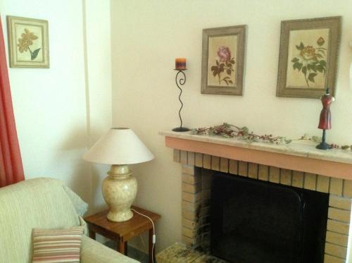 a living room with a fireplace and a lamp at Villa Sofia in Chrani