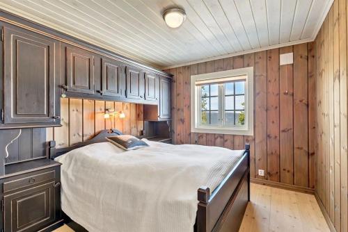 a bedroom with a large bed and a window at Gaustablikk hytta ski-in ski-out in Gaustablikk