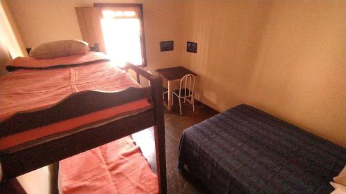 Un pat sau paturi într-o cameră la Oro Hospedaria