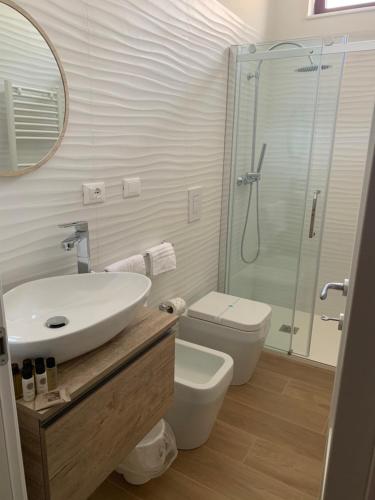 a bathroom with a sink and a toilet and a shower at B&B Palma Salentina in Lizzano