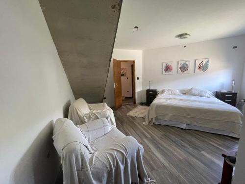 - une chambre avec 2 lits et un canapé dans l'établissement Casa Sierras de Córdoba Villa el Diquecito, à La Calera