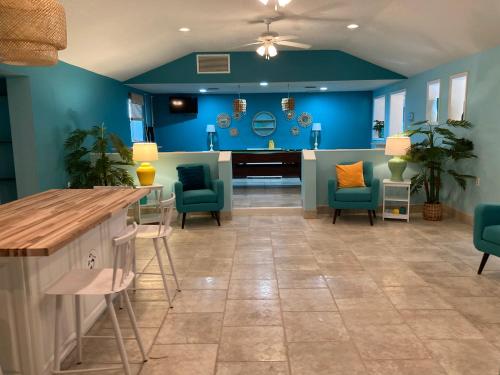 a lobby with blue walls and chairs and a bar at 3Gulls Inn Ozona-Boutique Hotel-Steps from Restaurants & Brewery-SwimSpa Pool-Pet Friendly in Palm Harbor
