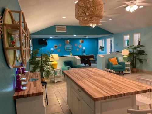 a kitchen with blue walls and a dining room at 3Gulls Inn Ozona-Boutique Hotel-Steps from Restaurants & Brewery-SwimSpa Pool-Pet Friendly in Palm Harbor