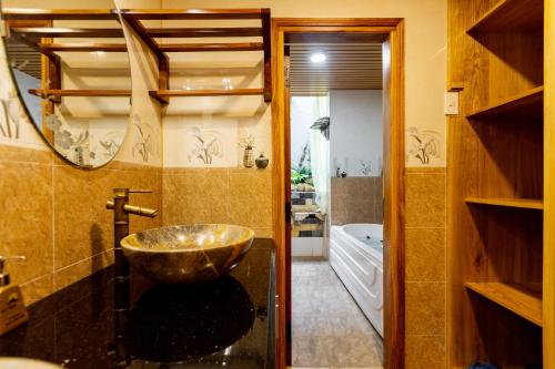 a bathroom with a bowl sink and a tub at Sea Night Hotel in Phan Thiet