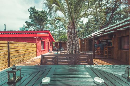 a wooden table with two white plates on top of it at RocaMar Hostel Boutique in Punta del Este