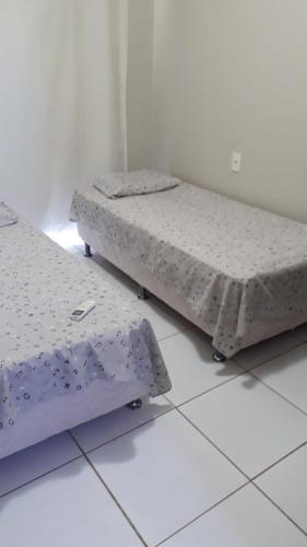 two beds sitting on the floor in a room at Apartamento Taiba Kite Beach Vista Mar in Taíba