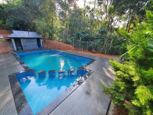an overhead view of a swimming pool in a yard at Vintage Garden Resort in Sultan Bathery