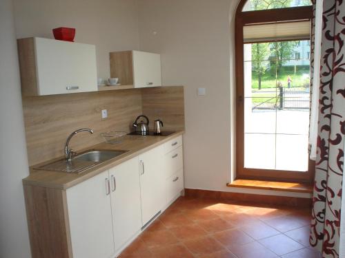 a kitchen with a sink and a window at Apartamenty Lawenda in Rabka