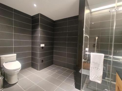 a bathroom with a toilet and a glass shower at Walden Hotel in Yilan City
