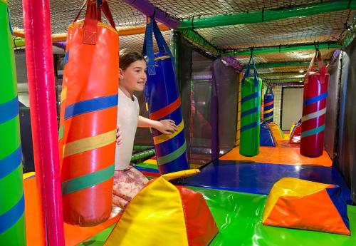 a woman is playing in a inflatable bounce gym at Mid City Motel Warrnambool in Warrnambool