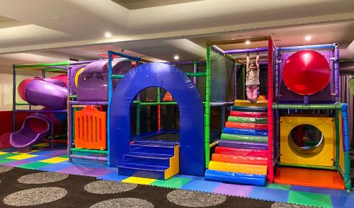 a play room with a slide and a playground at Mid City Motel Warrnambool in Warrnambool