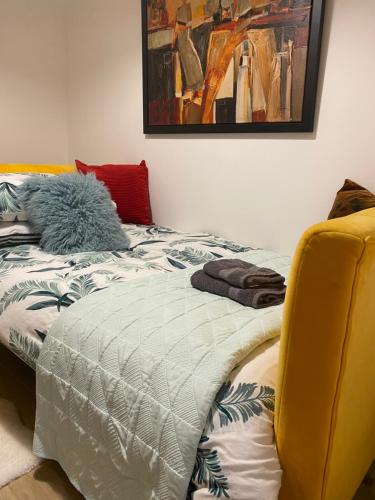 a bedroom with a bed with a comforter on it at Lovely 3 bed with jacuzzi, close to airport, driveway, wifi in Edinburgh