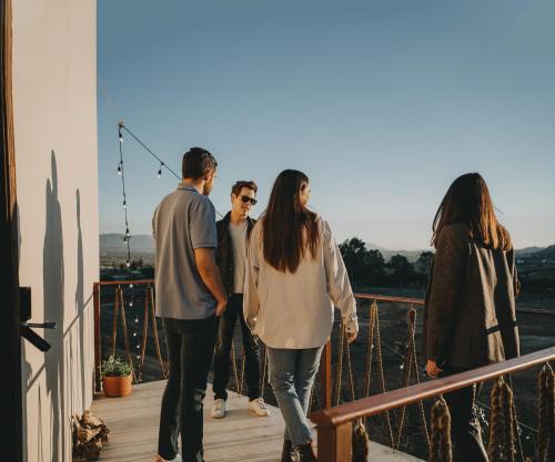 a group of people standing on a balcony at The Pangea Valle de Guadalupe in Valle de Guadalupe